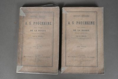 two old books sitting on top of a table next to each other