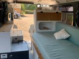a couch in the back of a camper van