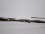 pair of antique brass - plated and black - and - white canes on a white surface