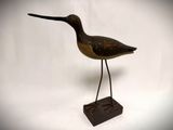 sculpture of a bird on a stand on a white background