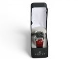 a watch in a black box with a red strap