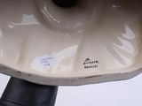 a close up view of a toilet bowl on a pedestal