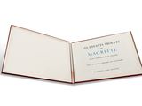 an open book on a white surface with a blue and red cover