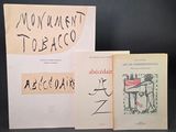 three books are sitting on a table with a black background