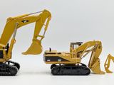three toy excavators sitting next to each other on a white surface