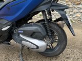 a blue motorcycle parked on the side of the road