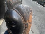 a statue of a fish on the side of the street