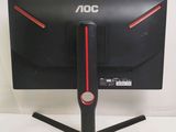 a black computer monitor with red trims on a stand