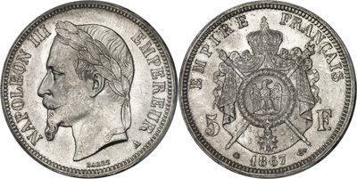 a close up of a silver coin with a crown on it