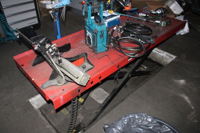 a red table with tools on it in a garage
