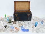 a small chest full of glass bottles and a small box full of glass bottles