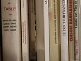 many books that are on a shelf in the room