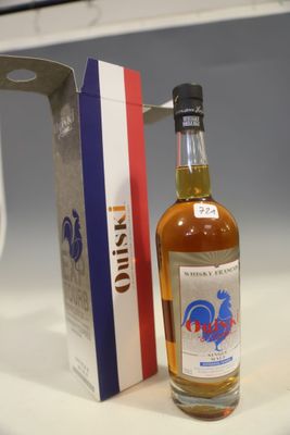 a bottle of alcohol sitting next to a box on a counter