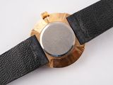 a close up of a watch on a white surface