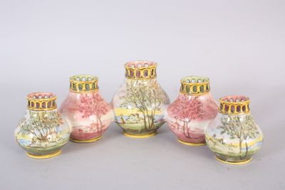 three vases with pink and yellow designs on them sitting next to each other