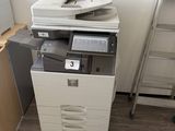 a printer sitting on top of a filing cabinet next to a ladder