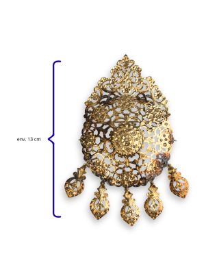 an image of a gold brooch with a white and brown design