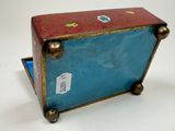 a small blue suitcase with a red cover on it