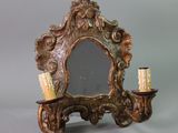 a mirror and a candle holder on a table