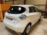 a picture of a small white car parked in a garage