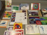 a table with many different stamps and postcards on it