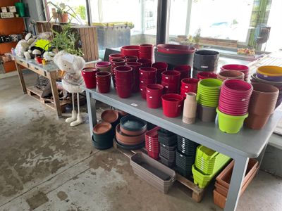 many pots and bowls on a table in a room