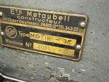 a close up of a machine with two wrenches on it
