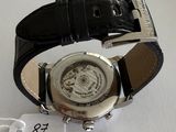 an image of a watch with a black leather strap on a white surface