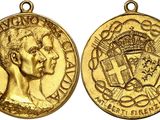 a close up of two gold medals on a white background