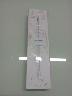 a white box with a toothbrush in it on a glass table