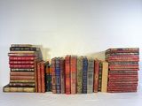 a lot of books stacked on top of each other on a table