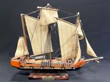 a model of a sailing ship on display on a table