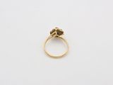 a close up of a gold ring with a black diamond