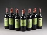 six bottles of wine lined up in a row on a table