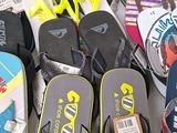 many pairs of flip flops that are on the floor