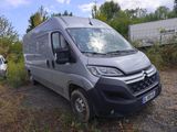 the grey van is parked on the side of the road