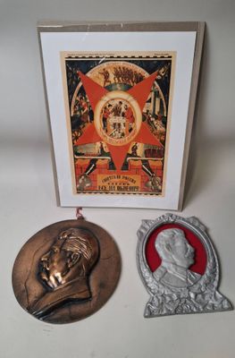 two medals and a card with a picture of a man and a woman