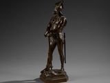 an image of a bronze statue of a man holding a cane