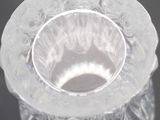 a clear glass candle holder on a black table