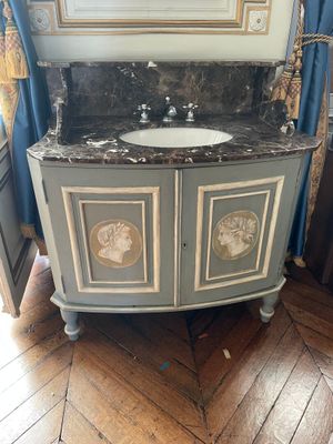a bathroom vanity with a marble counter top and a mirror