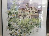 aquarelle encadrée représentant un village avec des marguerites en premier plan