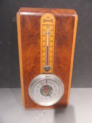 une horloge en bois à l'ancienne, équipée d'un thermomètre