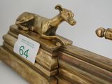 a gold statue of a horse and a dog running on a track