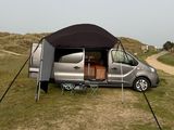 an image of a camper van parked in the grass