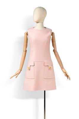 le mannequin porte une robe rose ornée de boutons