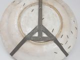 a white plate with a clock on it on the wall