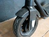 a scooter that is sitting on the floor in front of a wall