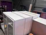 three refrigerators stacked on top of each other in a warehouse