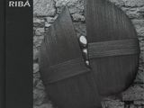 a black and white photo of a wooden shield on a wall