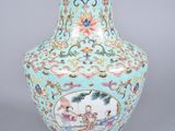 a blue vase with a picture of a man and a woman on it
